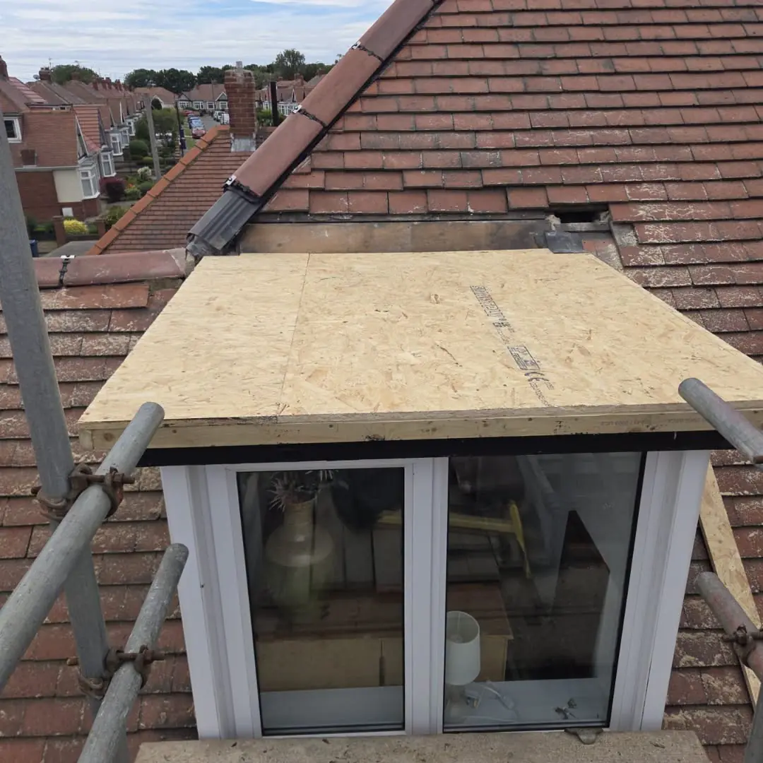 New 18mm OSB decking boards laid across the dormer top before the membrane