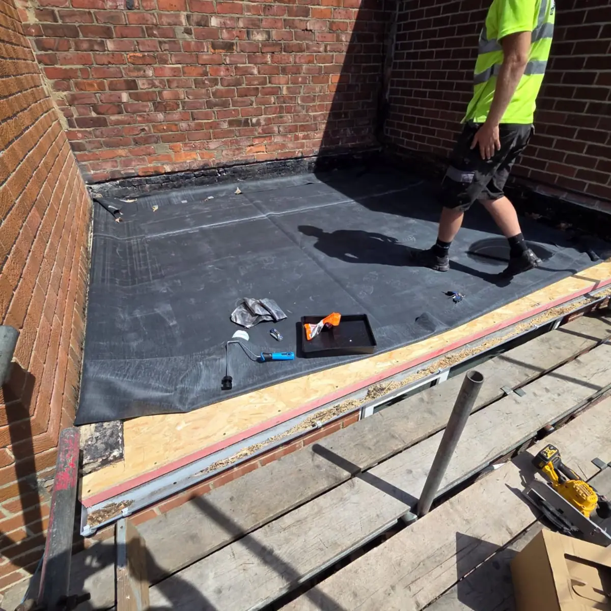 A new EPDM rubber membrane laid out over fresh OSB decking on a flat roof