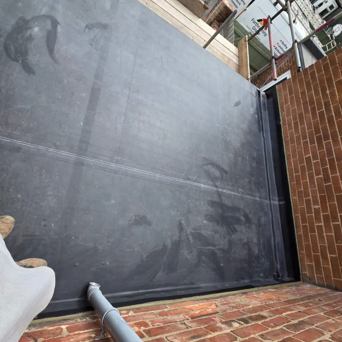 EPDM dressed up the surrounding brickwork in one piece to form a sealed upstand