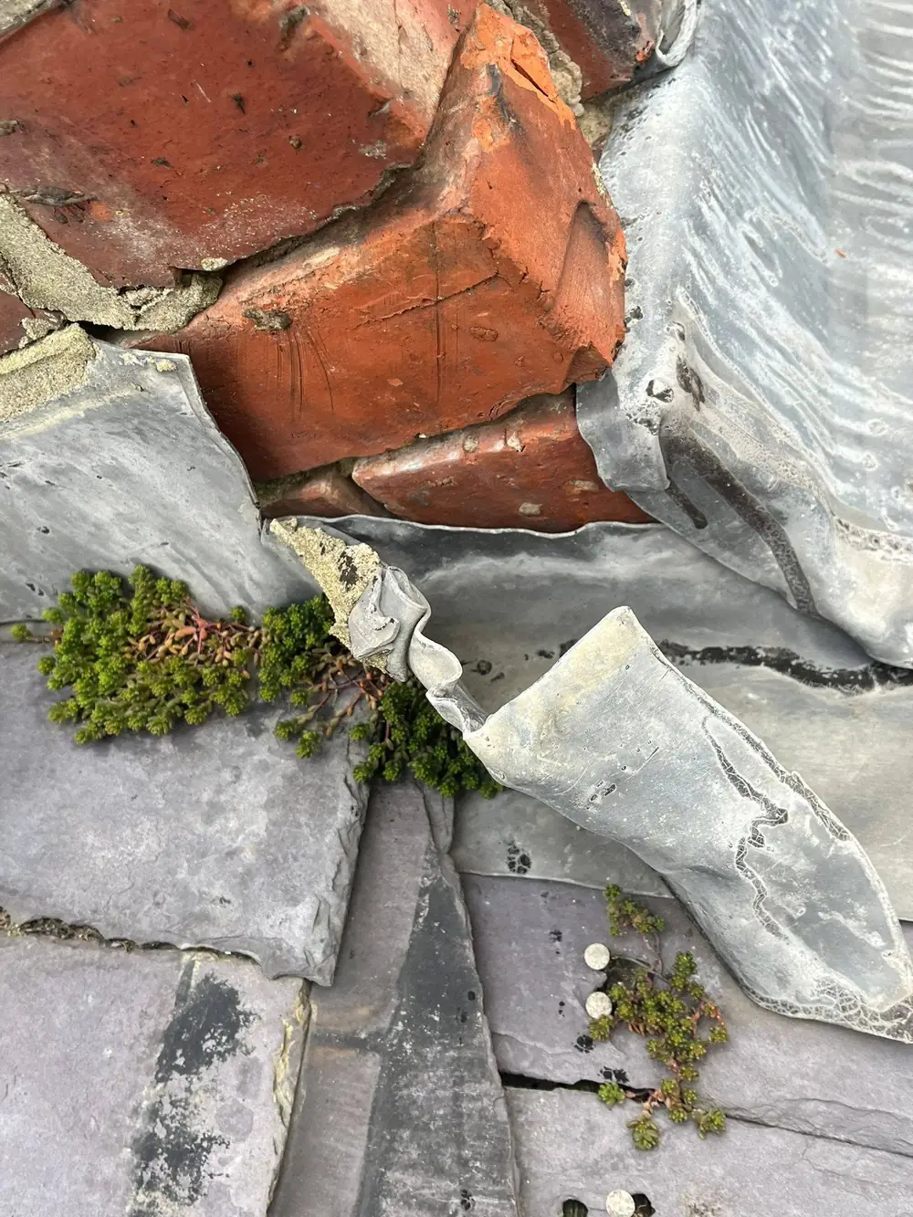 Step 2: inspecting lifted flashing and failed detailing on a roof