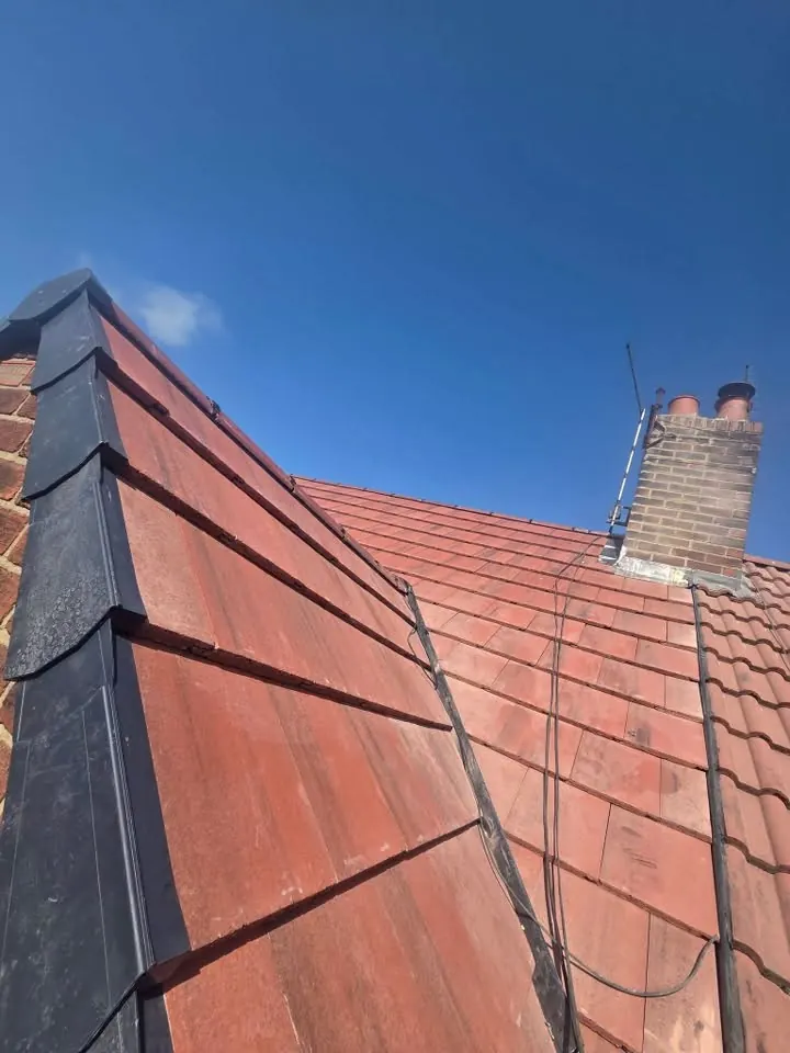Repointed chimney with new flashing alongside the new tiles and dry verge