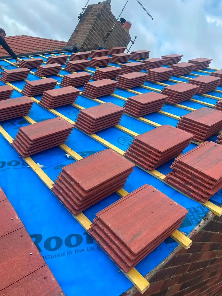 New breathable membrane and treated battens in place with tiles stacked ready for fixing