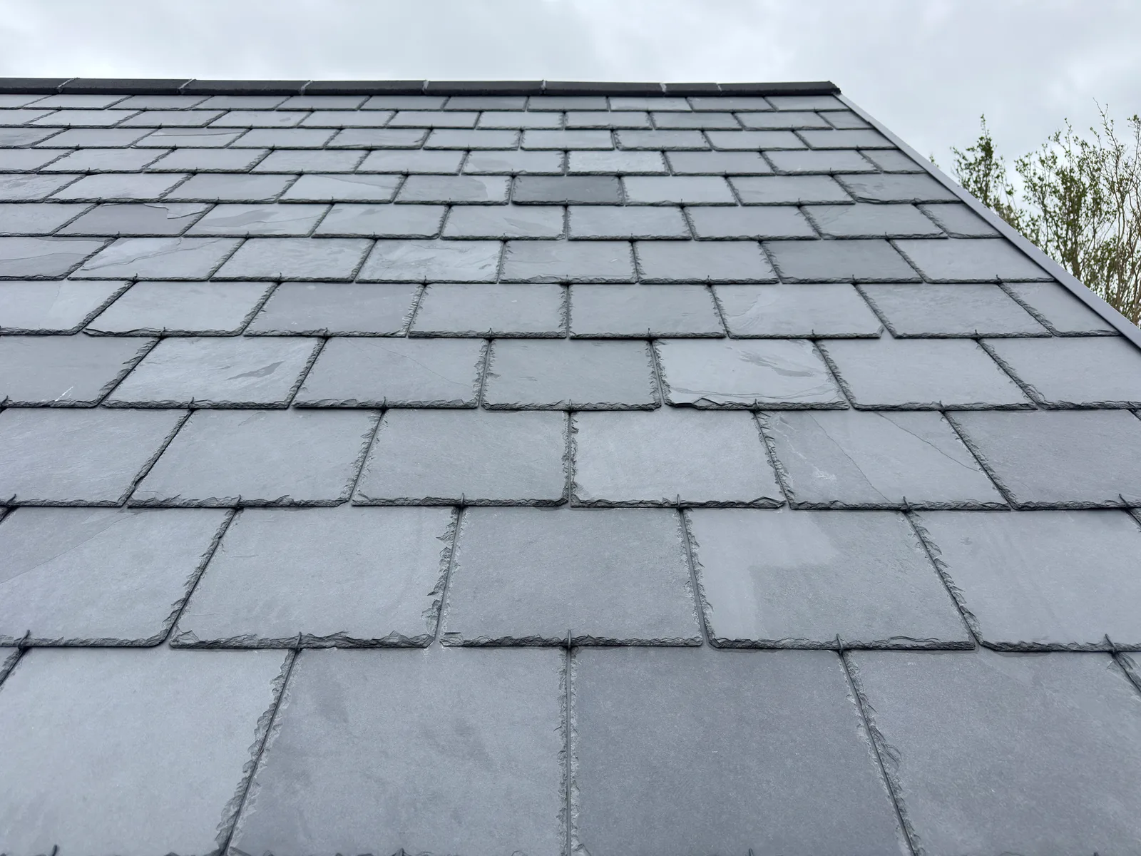 Step 2: slate hooks holding each course on a finished slate roof